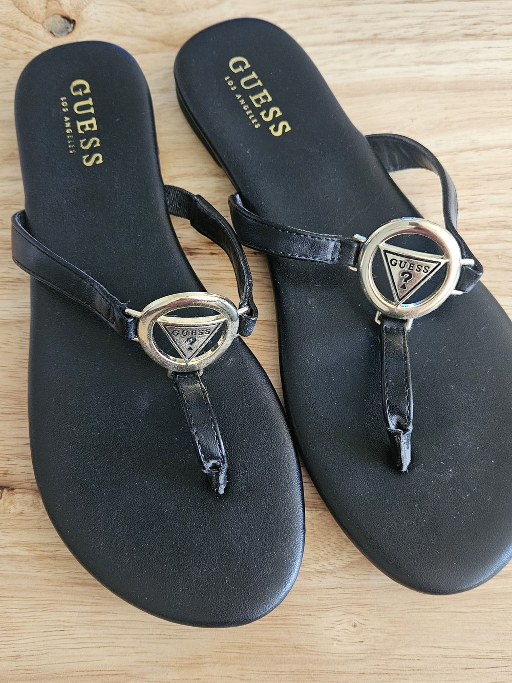 GUESS Black Thong Sandals with Gold Logo Medallion